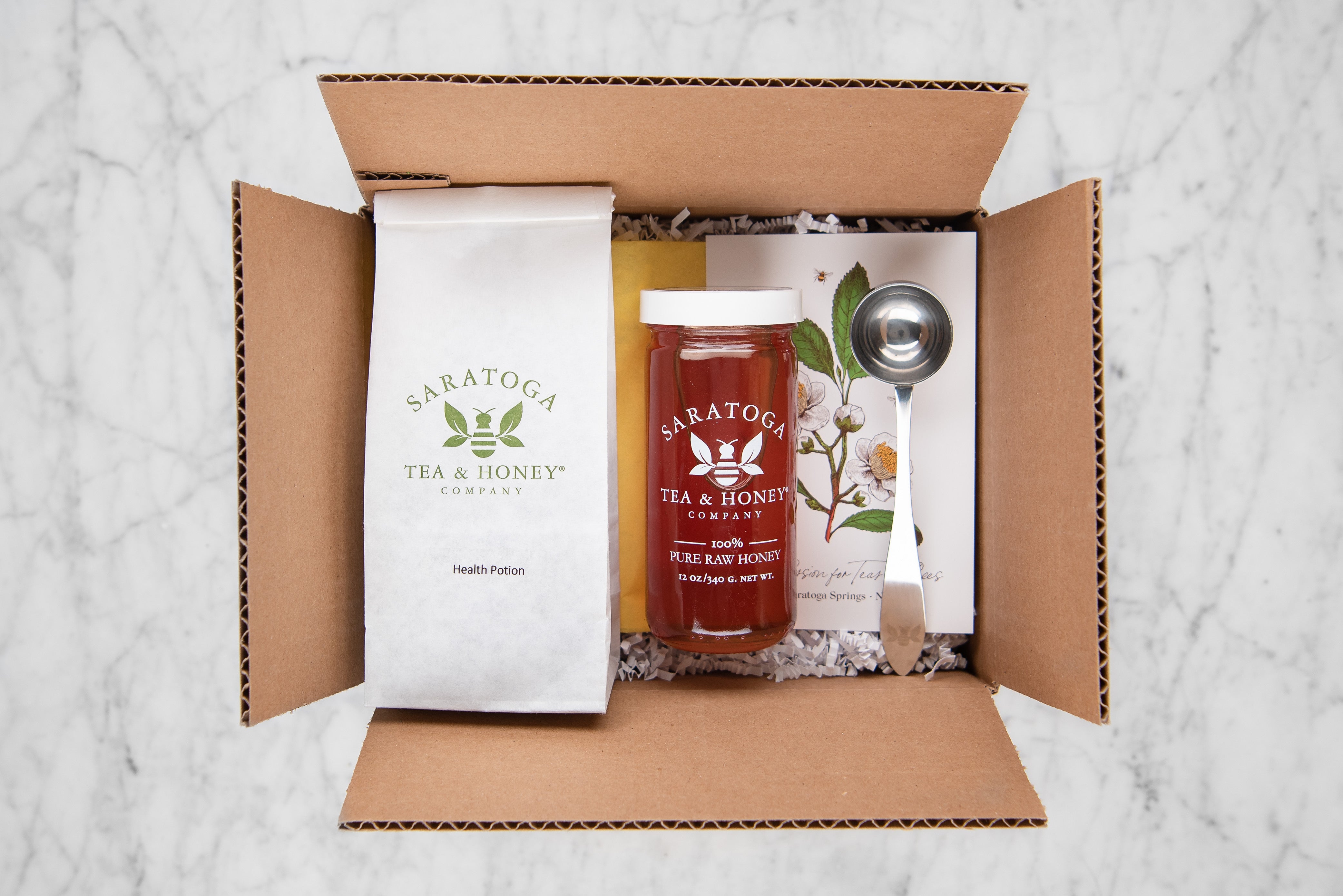 gift set with tea scoop, health potion herbal tisane, and raw honey