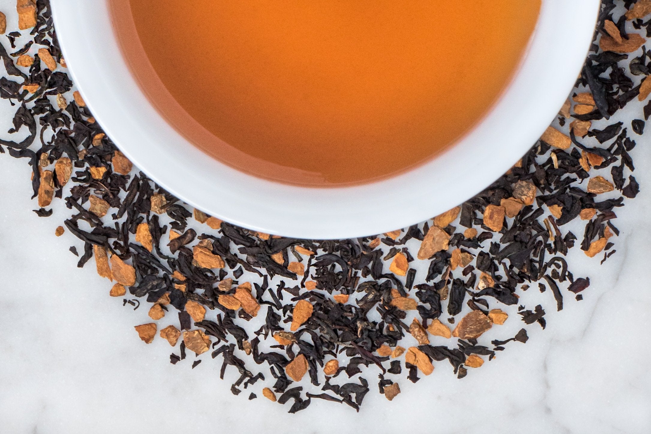 Indian Black Tea Leaves, Spicy Cinnamon and Apple Surround a Delicious Cup Of Spiced Brewed Istanbul Apple
