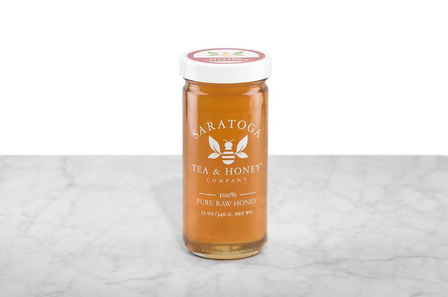 Amber-hued Italian Chestnut Honey displayed in a 12oz cylindrical glass jar with a white lid. The logo and the words: "100% Pure Raw Honey" are printed on the jar.