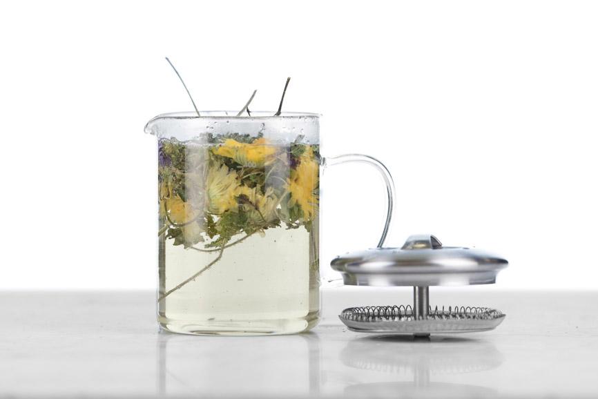 glass beaker infuser with stainless steel top/strainer shown with top off and full flower tea infusion