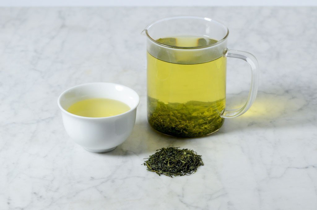 loose leaf sencha brewed in a glass infuser and white cup