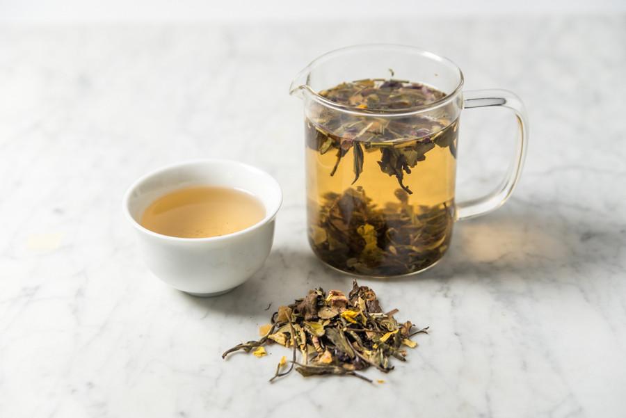 brewed strawberry tea in a glass infuser and white cup