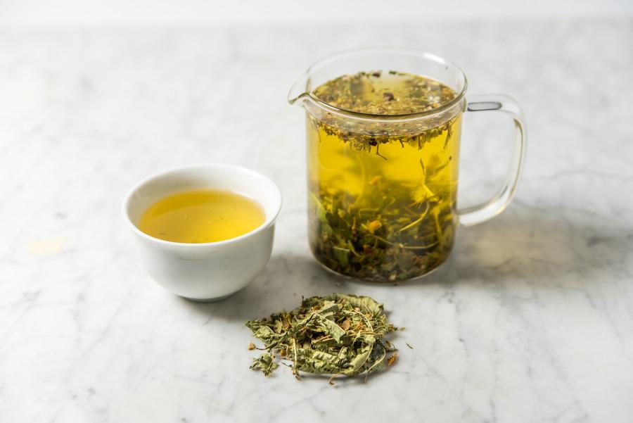 flu shot tea infused and presented in a white cup and glass infuser