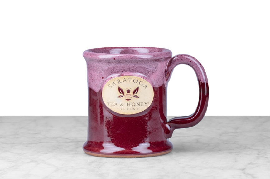 two-tone raspberry pink-purple microwave, oven, and dishwasher safe stoneware bee mug with saratoga tea and honey co logo