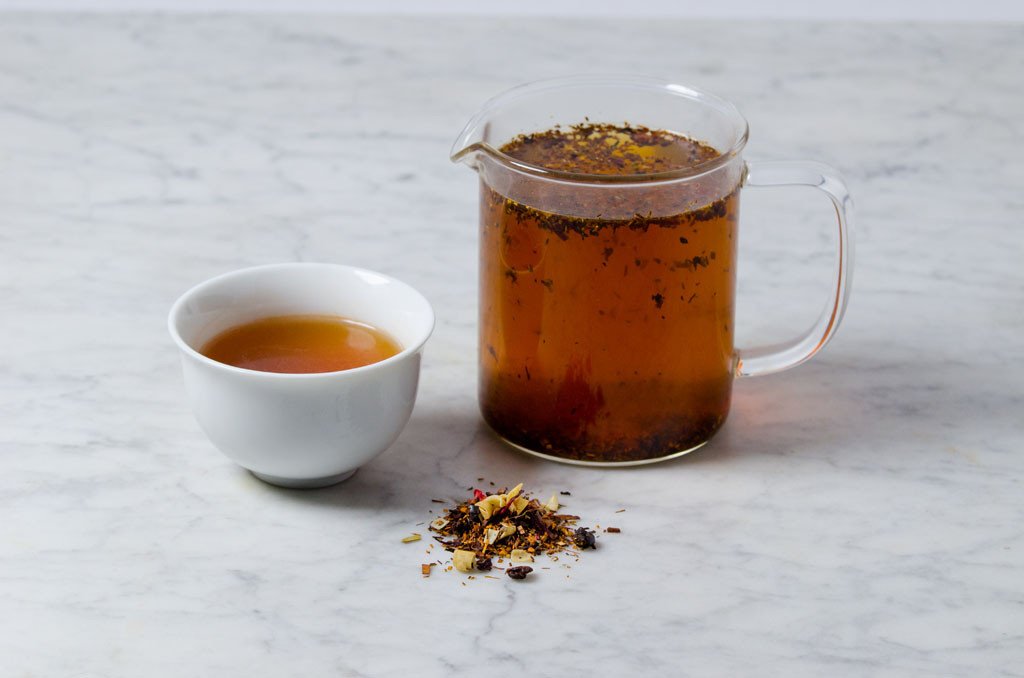 victorian vanilla berry tea infused in a glass pitcher and white cup