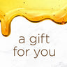 a gift for you written on marble background with drip of honey