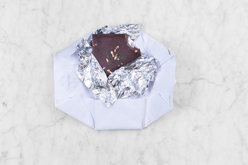 open dark chocolate bar with bite taken out of it
