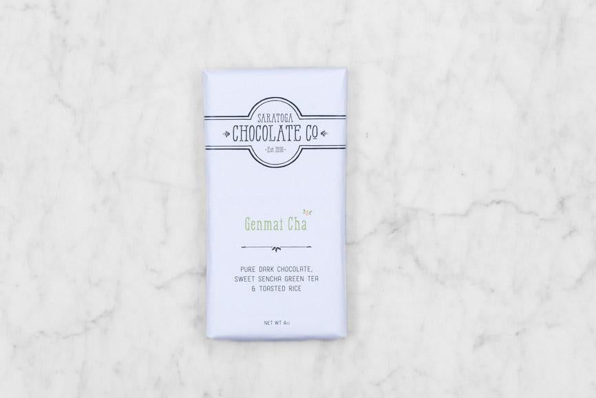 white paper wrapped Saratoga Chocolate Co. Genmai Cha Dark Chocolate Bard with Sencha Tea and crunchy popped rice
