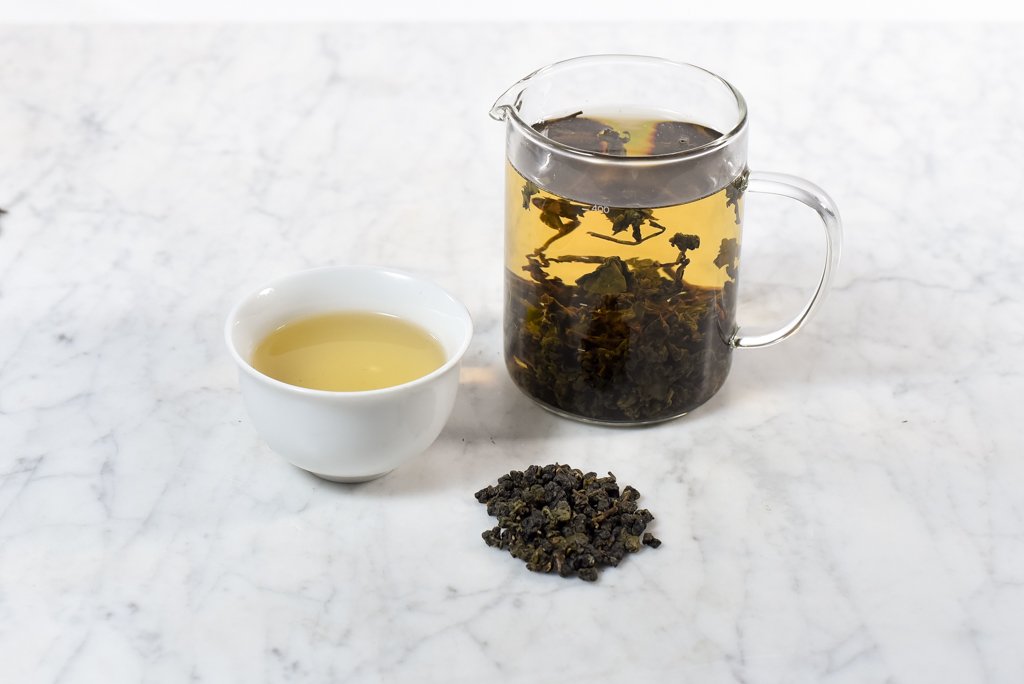 dong ding roasted oolong brewed in a glass infuser and poured into a white cup