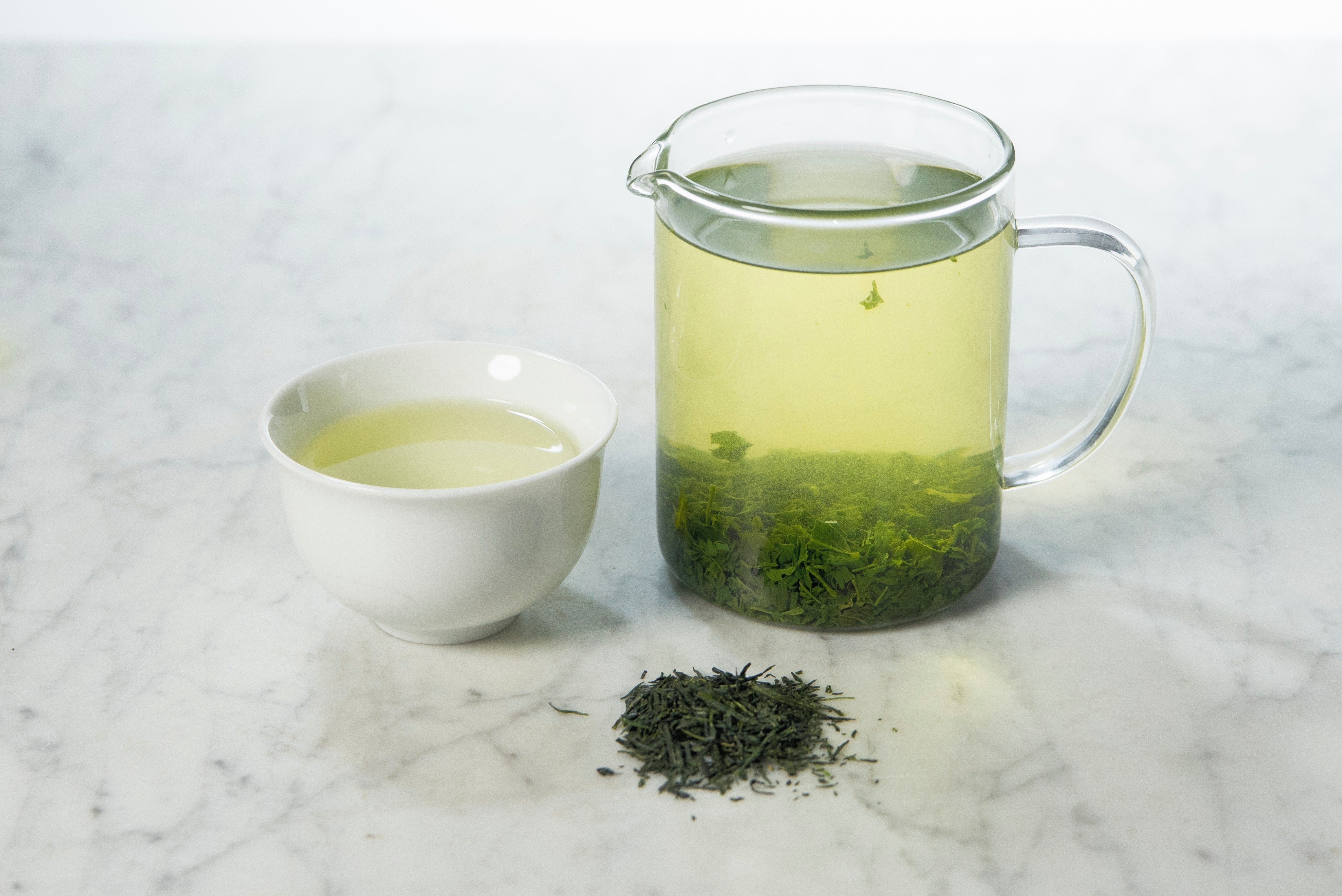 sweet and vegetal loose leaf green tea brewed in a glass infuser and white cup