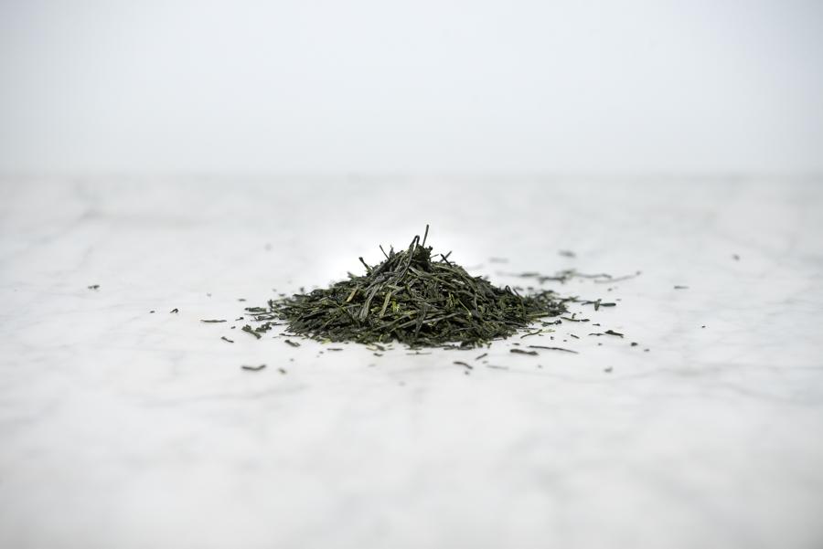 shade grown japanese green tea loose leaf tea leaves on a marble background