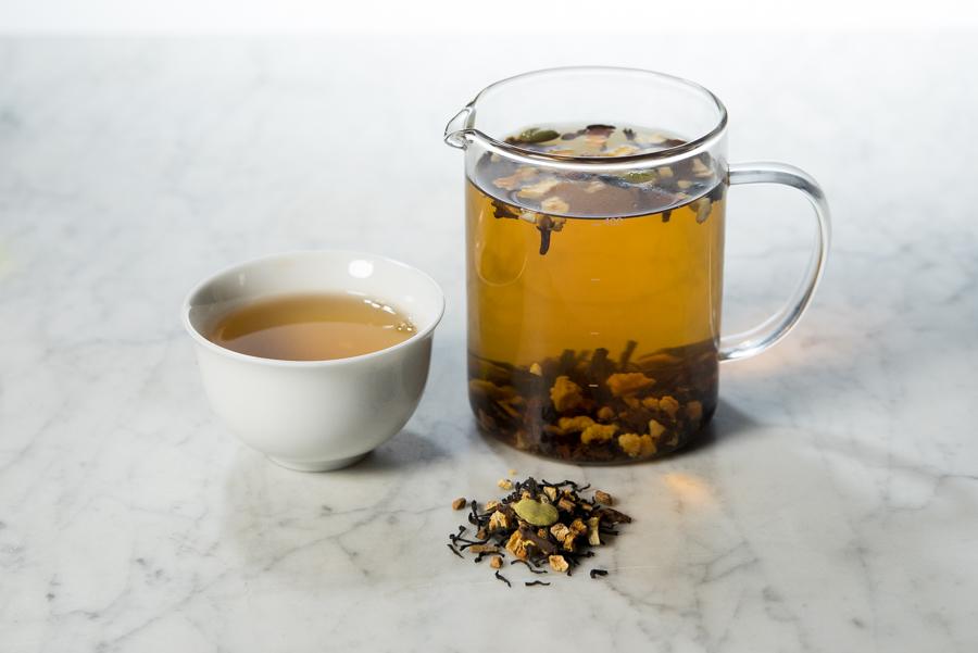 winter citrus tea brewed in a glass infuser and white cup