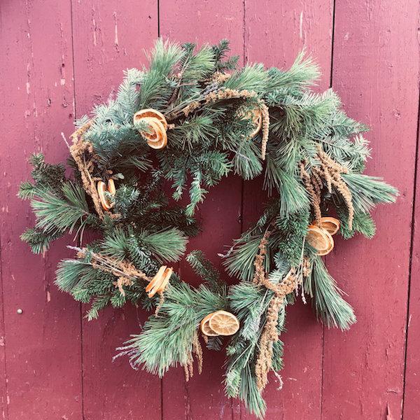evergreen wreath on a red wall