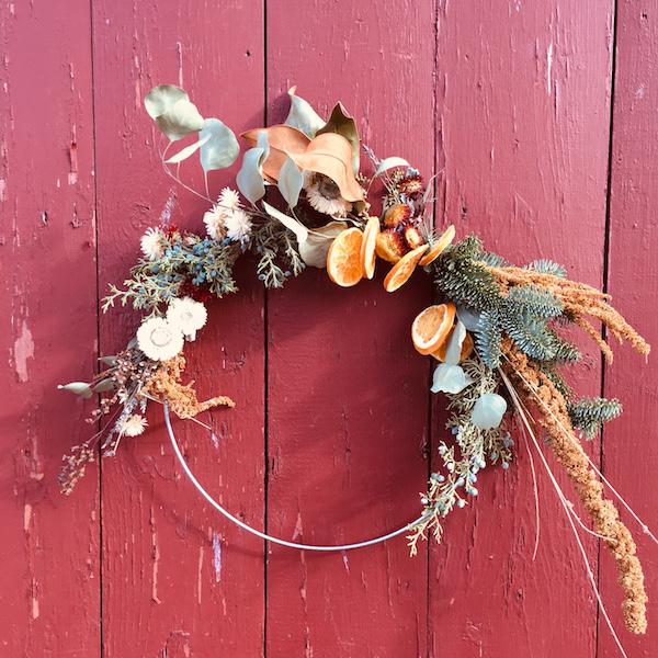 contemporary asymmetrical wreath on a red wall